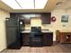 Modern kitchen with dark cabinets, granite counters and stainless steel appliances at 3550 Bay Sands Dr # 1017, Laughlin, NV 89029