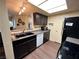 Modern kitchen with dark cabinets, granite counters, and stainless steel appliances at 3550 Bay Sands Dr # 1017, Laughlin, NV 89029