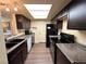 Modern kitchen with dark cabinets, granite counters, and stainless steel appliances at 3550 Bay Sands Dr # 1017, Laughlin, NV 89029
