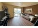Living room with sofa, TV, and access to balcony at 3550 Bay Sands Dr # 1017, Laughlin, NV 89029