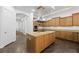 Island kitchen with wood cabinetry and stainless steel appliances at 3757 Brittany Nicole Ct, Las Vegas, NV 89139