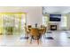 Bright dining area with a glass table and four mustard-yellow chairs at 4002 Extenso Dr, North Las Vegas, NV 89032