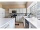 Modern kitchen with white cabinets, stainless steel appliances, and quartz countertops at 4002 Extenso Dr, North Las Vegas, NV 89032