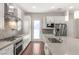 Modern kitchen with stainless steel appliances and gray herringbone backsplash at 4255 Veraz St, Las Vegas, NV 89135