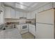 White kitchen features granite countertops and stainless steel appliances at 4770 Topaz St # 77, Las Vegas, NV 89121