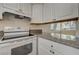 White cabinets and granite countertops in this kitchen at 4770 Topaz St # 77, Las Vegas, NV 89121