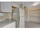 Kitchen with white appliances and granite countertops at 4770 Topaz St # 77, Las Vegas, NV 89121