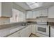 Bright kitchen with white cabinets, granite countertops, and stainless steel appliances at 4770 Topaz St # 77, Las Vegas, NV 89121