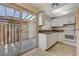 White kitchen with granite countertops and patio access at 4770 Topaz St # 77, Las Vegas, NV 89121
