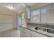 Kitchen with granite countertops, white cabinets, and access to a patio at 4770 Topaz St # 77, Las Vegas, NV 89121