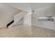 Open living room with tile floors and staircase at 4770 Topaz St # 77, Las Vegas, NV 89121
