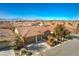 Aerial view showing a two-story home with a three-car garage and desert landscaping at 4880 Da Vinci Way, Pahrump, NV 89061