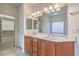 Double vanity bathroom with walk-in closet access at 4880 Da Vinci Way, Pahrump, NV 89061