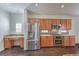 Modern kitchen with stainless steel appliances and wood cabinetry at 4880 Da Vinci Way, Pahrump, NV 89061