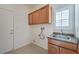 Laundry room with upper cabinets, sink, and space for washer/dryer at 4880 Da Vinci Way, Pahrump, NV 89061
