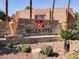 Stone Bella Vita community sign with desert landscaping and palm trees, welcoming residents and visitors alike at 5493 Indian River Dr # 383, Las Vegas, NV 89103