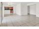 Open-concept living room with tile flooring, access to the kitchen and balcony, creating a spacious and bright atmosphere at 5493 Indian River Dr # 383, Las Vegas, NV 89103