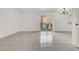 Spacious living room featuring tile flooring, sliding door access to a balcony, and neutral decor, ready for personal touches at 5493 Indian River Dr # 383, Las Vegas, NV 89103