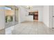 Bright living room featuring tile floors, balcony access, and an open connection to the kitchen area for modern living at 5493 Indian River Dr # 383, Las Vegas, NV 89103