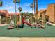 A colorful playground with a slide, swings, and soft ground cover in a community setting at 5493 Indian River Dr # 383, Las Vegas, NV 89103