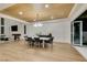 Open concept dining room with large table, modern chandelier, and fireplace at 5573 San Florentine Ave, Las Vegas, NV 89141