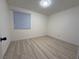 Well-lit bedroom with light gray laminate flooring and window with blinds at 5905 Smoke Ranch Rd # A, Las Vegas, NV 89108
