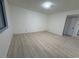 Bright bedroom with light gray laminate flooring and neutral walls at 5905 Smoke Ranch Rd # A, Las Vegas, NV 89108