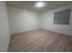 Bright bedroom featuring light gray laminate flooring and neutral walls at 5905 Smoke Ranch Rd # A, Las Vegas, NV 89108