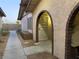 Front view of the property showing a walkway to an arched entryway at 5905 Smoke Ranch Rd # A, Las Vegas, NV 89108