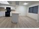 Kitchen with white cabinets, black appliances, and light gray flooring at 5905 Smoke Ranch Rd # A, Las Vegas, NV 89108