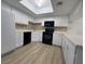 Updated kitchen with white cabinets, black appliances and a skylight at 5905 Smoke Ranch Rd # A, Las Vegas, NV 89108