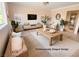 Professionally staged living room featuring light wood furniture and a neutral color palette at 5905 Smoke Ranch Rd # A, Las Vegas, NV 89108