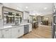 Eat-in kitchen with white shaker cabinets and marble countertops at 6413 Peppermill Dr, Las Vegas, NV 89146