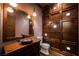 Elegant bathroom with copper sink and wood wall at 646 Saint Croix St, Henderson, NV 89012