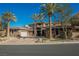 Luxury home with stone exterior, palm trees, and gated entry at 646 Saint Croix St, Henderson, NV 89012