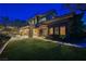 Beautiful two-story home with lush green lawn, stone accents, and manicured landscaping at 646 Saint Croix St, Henderson, NV 89012