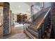 Elegant grand staircase with dark wood and metal accents at 646 Saint Croix St, Henderson, NV 89012