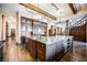Large kitchen with L-shaped island, dark wood cabinets and granite counters at 646 Saint Croix St, Henderson, NV 89012