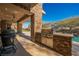 Stone outdoor kitchen with built-in grill and large island at 646 Saint Croix St, Henderson, NV 89012