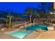 Inviting pool and spa with rock waterfall, slide, and lush tropical landscaping for a backyard oasis at 646 Saint Croix St, Henderson, NV 89012