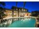 Gorgeous backyard pool and spa featuring stone accents, outdoor kitchen and ambient lighting at 646 Saint Croix St, Henderson, NV 89012