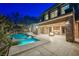 Stunning home exterior with a sparkling pool, fire pit, and covered patio with stone columns at 646 Saint Croix St, Henderson, NV 89012