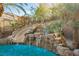 Waterfall and slide feature in a luxurious pool setting at 646 Saint Croix St, Henderson, NV 89012