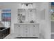 Modern bathroom with a double sink vanity with two rectangular mirrors and tub at 6586 W Mesa Vista Ave, Las Vegas, NV 89118