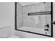Modern bath and shower features a black trim and large white marble-style tiles at 6586 W Mesa Vista Ave, Las Vegas, NV 89118