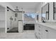 Bathroom featuring glass enclosed shower, tub, and double vanity at 6586 W Mesa Vista Ave, Las Vegas, NV 89118