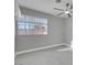 Bright bedroom features hardwood floors, gray walls, and a window with blinds at 6586 W Mesa Vista Ave, Las Vegas, NV 89118