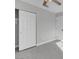 Bedroom features hardwood floors and gray walls, with a sliding closet door and a second entry door at 6586 W Mesa Vista Ave, Las Vegas, NV 89118