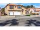 Two-story home featuring a three-car garage, front lawn, and desert landscaping at 6586 W Mesa Vista Ave, Las Vegas, NV 89118