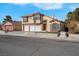 Charming two-story home with three-car garage, manicured lawn, and a tile roof at 6586 W Mesa Vista Ave, Las Vegas, NV 89118